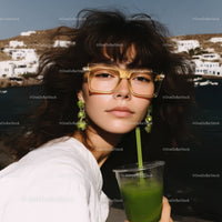 Fashionable woman in sunglasses enjoying a sunny day by the sea