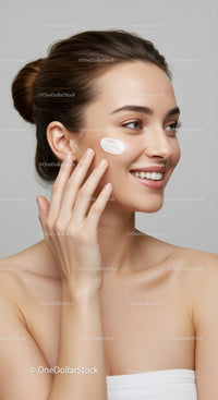 Portrait of a Smiling Woman Applying Cream on Her Cheek for Skincare