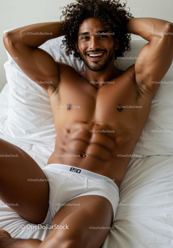 Smiling shirtless man relaxing on bed in white underwear