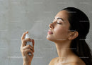 Young woman using facial mist for skincare and hydration
