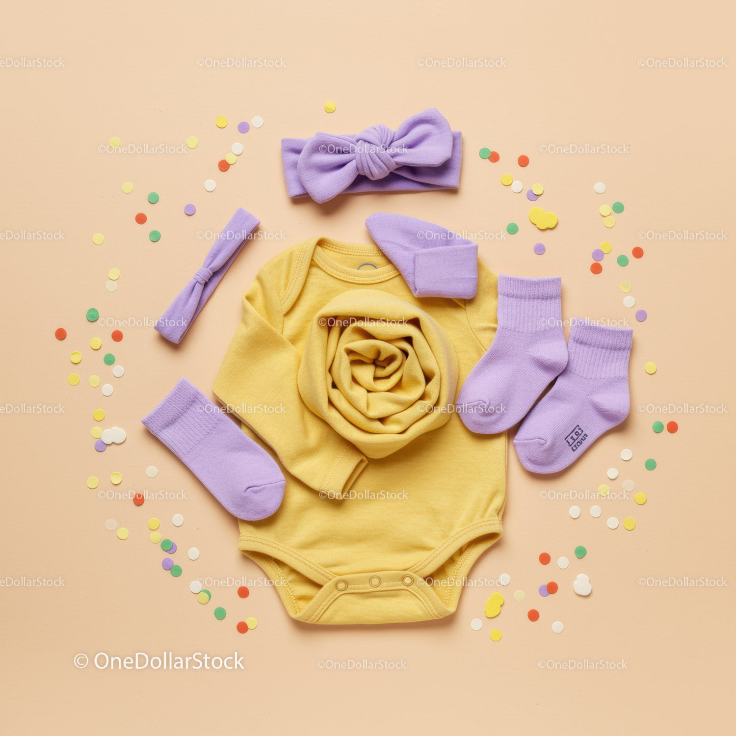 Yellow Baby Onesie with Lavender Accessories on Peach