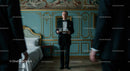Elegant Waiter in a Luxurious Vintage Setting Serving Drinks
