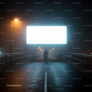 Silhouetted person walking under illuminated billboard on foggy bridge