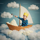 Child with paper crown sailing in ice cream boat