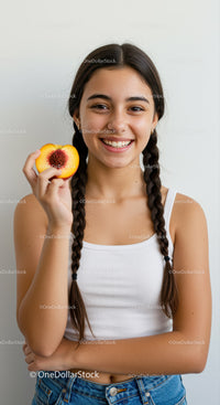 Joyful Teen Girl Holding Peach with Bright Smile and Braided Hair