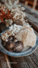 Various Edible Wild Mushrooms on Rustic Wooden Plate