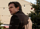 Thoughtful man near decorated Christmas tree outdoors