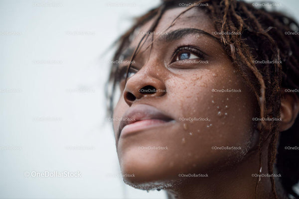Close-up of Black Woman with Water Droplets and Natural Glow