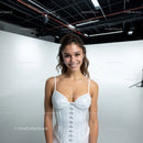 Bright Young Woman Smiling in White Corset in Studio Setting