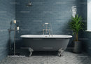 Vintage clawfoot bathtub in modern tiled bathroom