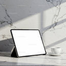 Digital tablet and coffee cup on marble countertop