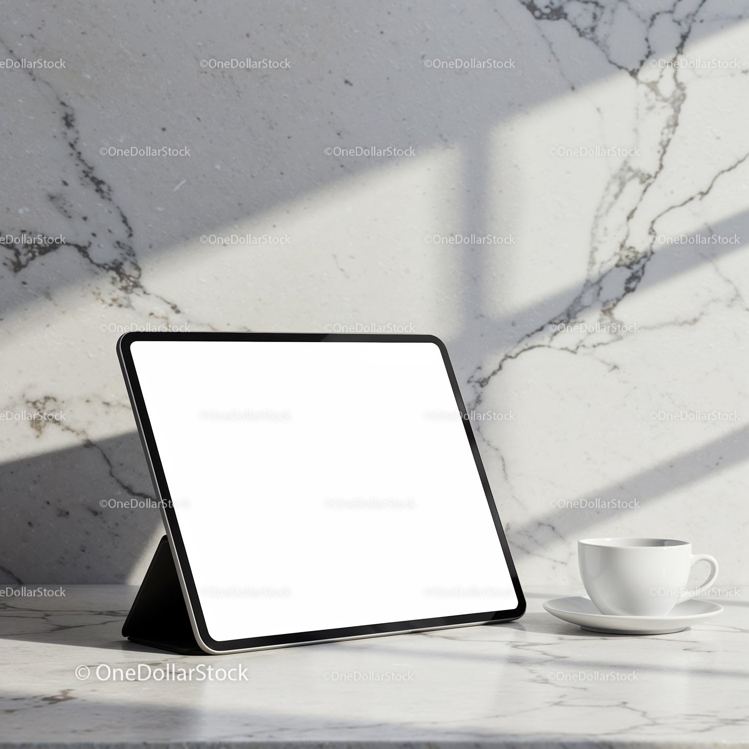 Digital tablet and coffee cup on marble countertop