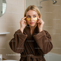 Woman Applying Gold Under-Eye Patches in Spa Setting