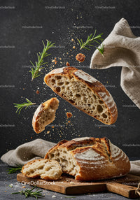 Rustic sourdough bread flying with fresh rosemary herbs