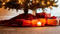 Christmas gifts and candlelight under a decorated tree