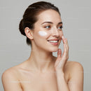 Elegant Young Woman Applying Face Cream with Skincare Routine