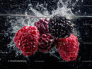 Fresh Raspberries and Blackberries Splashing in Water