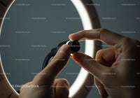 Close-up of Hand Adjusting a Black Dial Wristwatch