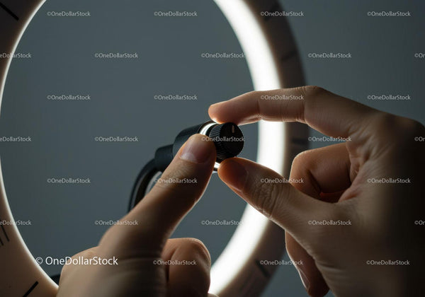 Close-up of Hand Adjusting a Black Dial Wristwatch