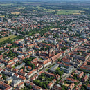 Aerial View of Historic Town with Red-Tiled Roofs and Green Parks
