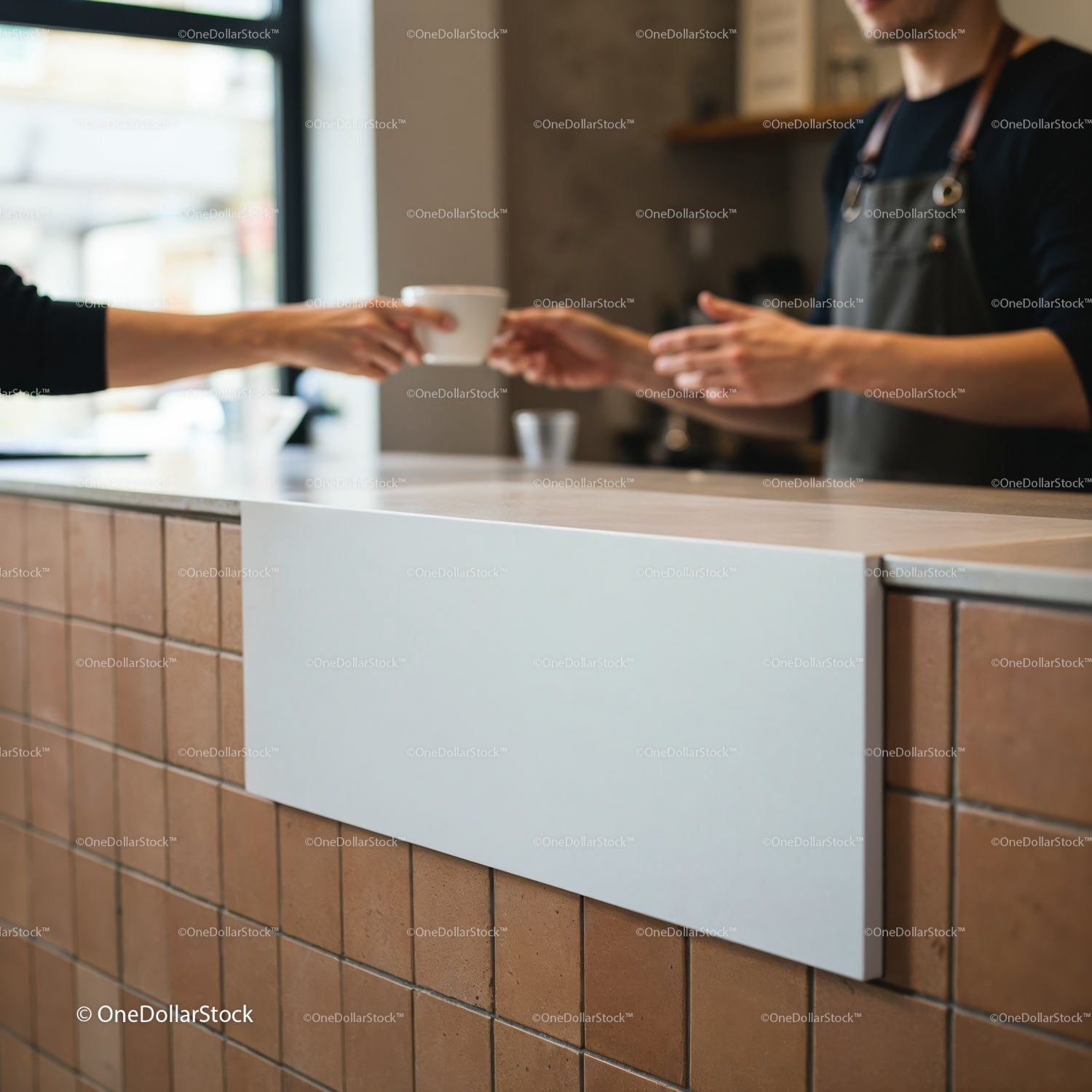 Barista handing a cup of coffee over counter in cafe