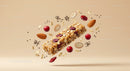 Granola Bar Surrounded by Cranberries and Nuts in Air
