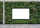 Blank advertising board framed by lush green vertical garden