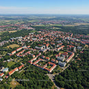 Aerial View of Green Suburban Neighborhood with Red Roofs and Trees