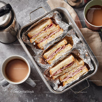 Ham and Cheese Club Sandwich on Aluminum Foil with Coffee and Tea