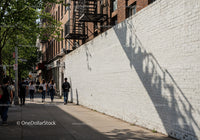 Urban Street Scene with Pedestrians and Building Shadows