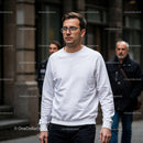 Man in white sweatshirt walking in urban street JPG Mockup Image preview