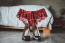 Chic Black Heels and a Red Lace Dress in a Cozy Bedroom Setting
