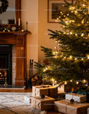 Cozy living room with lit Christmas tree and wrapped gifts