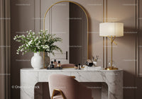 Elegant marble vanity with soft pink chair and floral decor