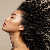 Profile of woman with flowing curly hair and smooth skin