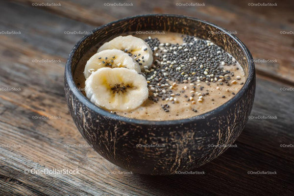 Nutritious Banana Chia Smoothie Bowl in Rustic Coconut Bowl
