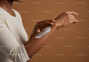 Close-Up of Woman Applying Moisturizer on Hand for Skin Hydration