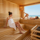 Relaxing Women in Wooden Sauna with Scenic Beach View