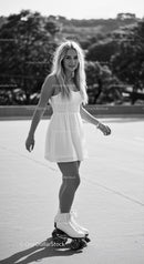 Young woman roller skating in a sunny outdoor setting