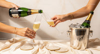 Women Toasting Champagne Glasses in a Party Scene with Ice Bucket