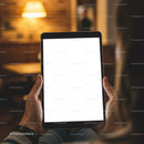 Person Holding Tablet with Blank Screen in Cozy Room