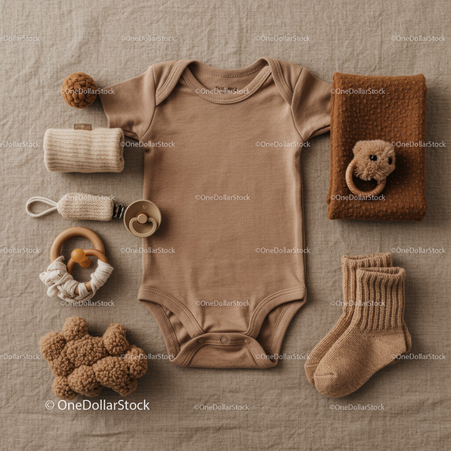 Neutral toned baby clothing and accessories flat lay