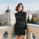 Elegant Woman in Black Lace Dress on City Balcony with Scenic View