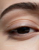 Close up of woman's brown eye with natural skin texture