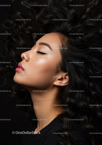 Calm woman with closed eyes and flowing curly hair