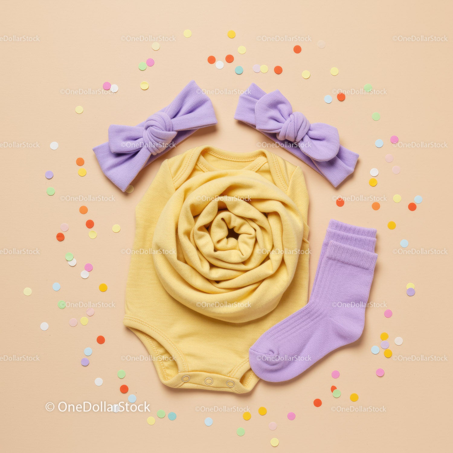 Yellow Baby Onesie with Lilac Accessories and Confetti
