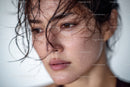 Close-up of a woman with wet hair and water droplets on her skin