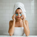 Woman relaxing with under eye patches in bathroom