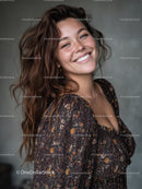 Bright Smiling Woman in Floral Dress with Curly Brown Hair