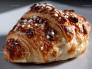 Chocolate Chip Croissant with Powdered Sugar and Flaky Layers